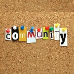 Community written in printed letters pinned on to a cork noticeboard