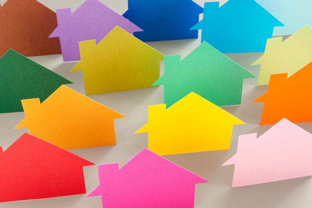Group of different colorful houses cut out of paper